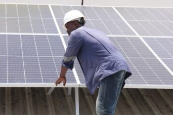 An engineer observes the operation of solar panels in Cotonou, Benin.