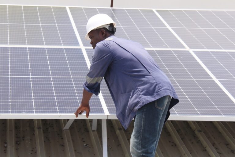 An engineer observes the operation of solar panels in Cotonou, Benin.
