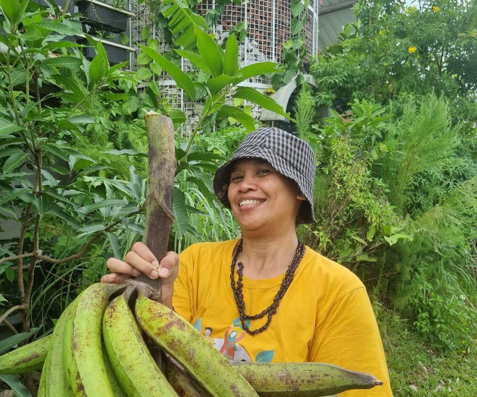 Sapariah Saturi with bananas from her yard. Photo courtesy of Saturi.