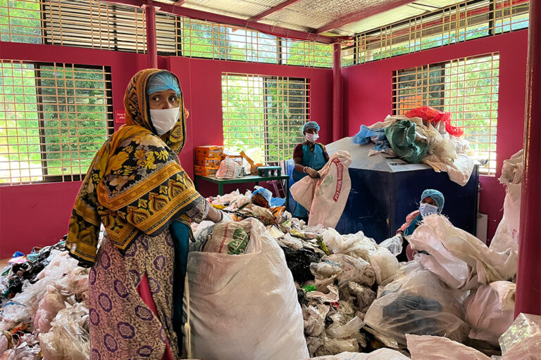 Workers at BRAC's plastic project sort out single-use plastics.