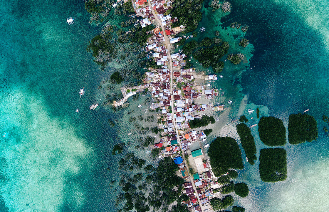 Filipinos wade through floodwaters due to sinking land, rising sea & corruption