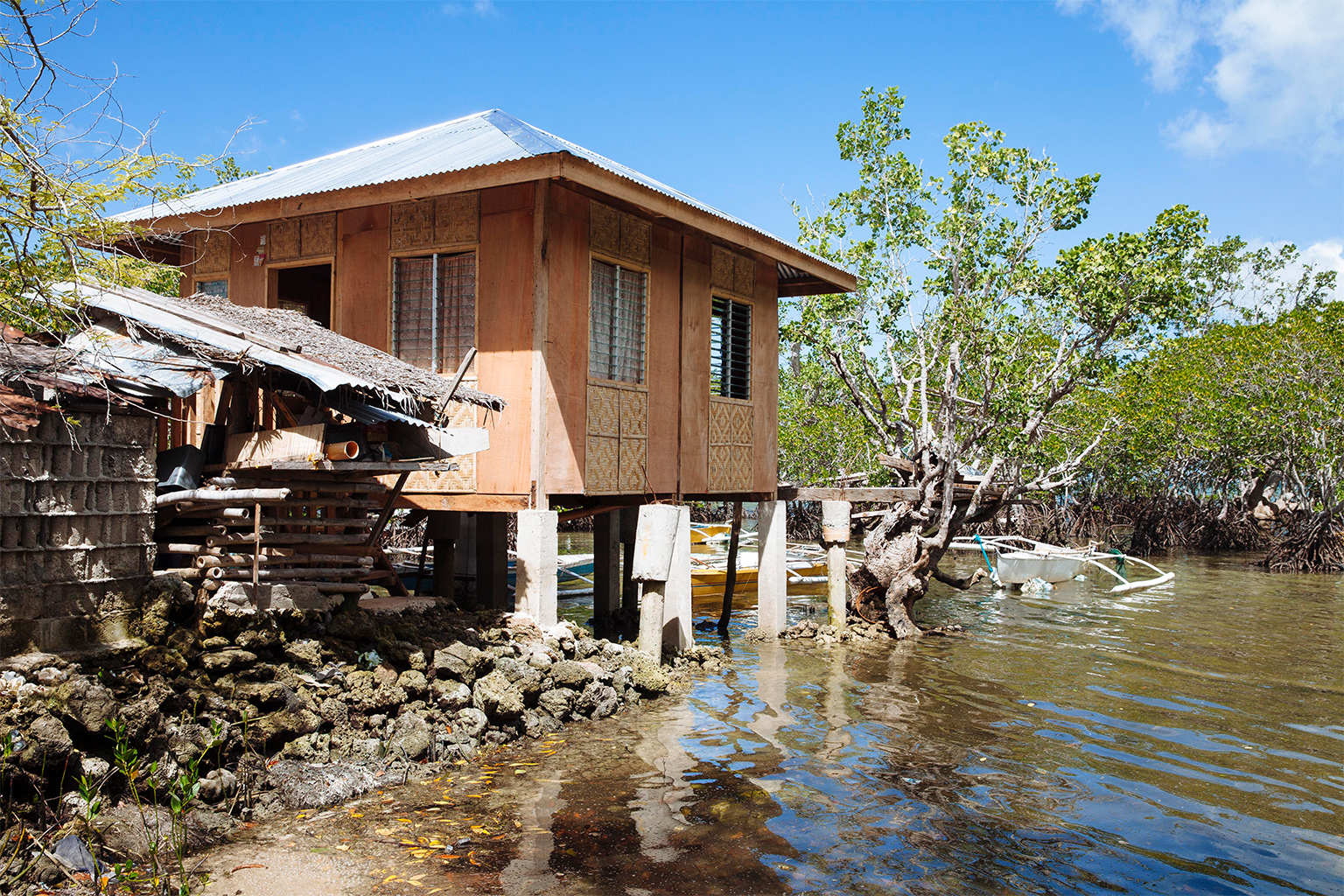 Homes are built on stilts or have second floors to adapt to the rising water.