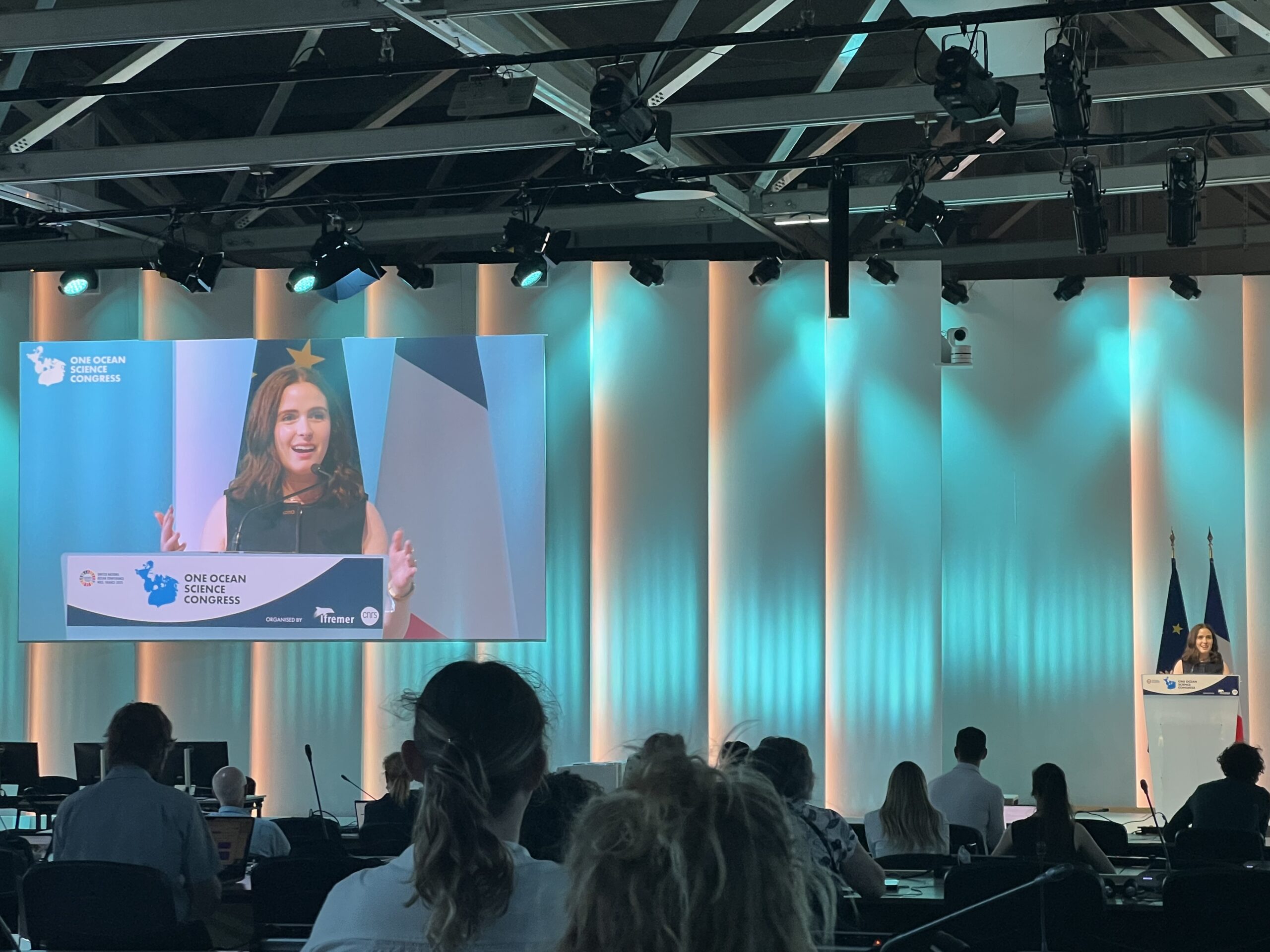 Gabrielle Carmine, lead author of the new Environmental Research Letters paper, speaks about high seas fisheries governance and the future of the high seas treaty at the One Ocean Science Congress in Nice, France, in June 2025. The conference preceded the U.N. Ocean Conference. Image courtesy of Gabrielle Carmine. 