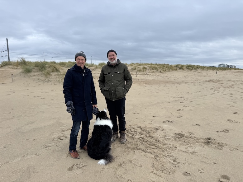 Experts standing in front of dunes in Belgium