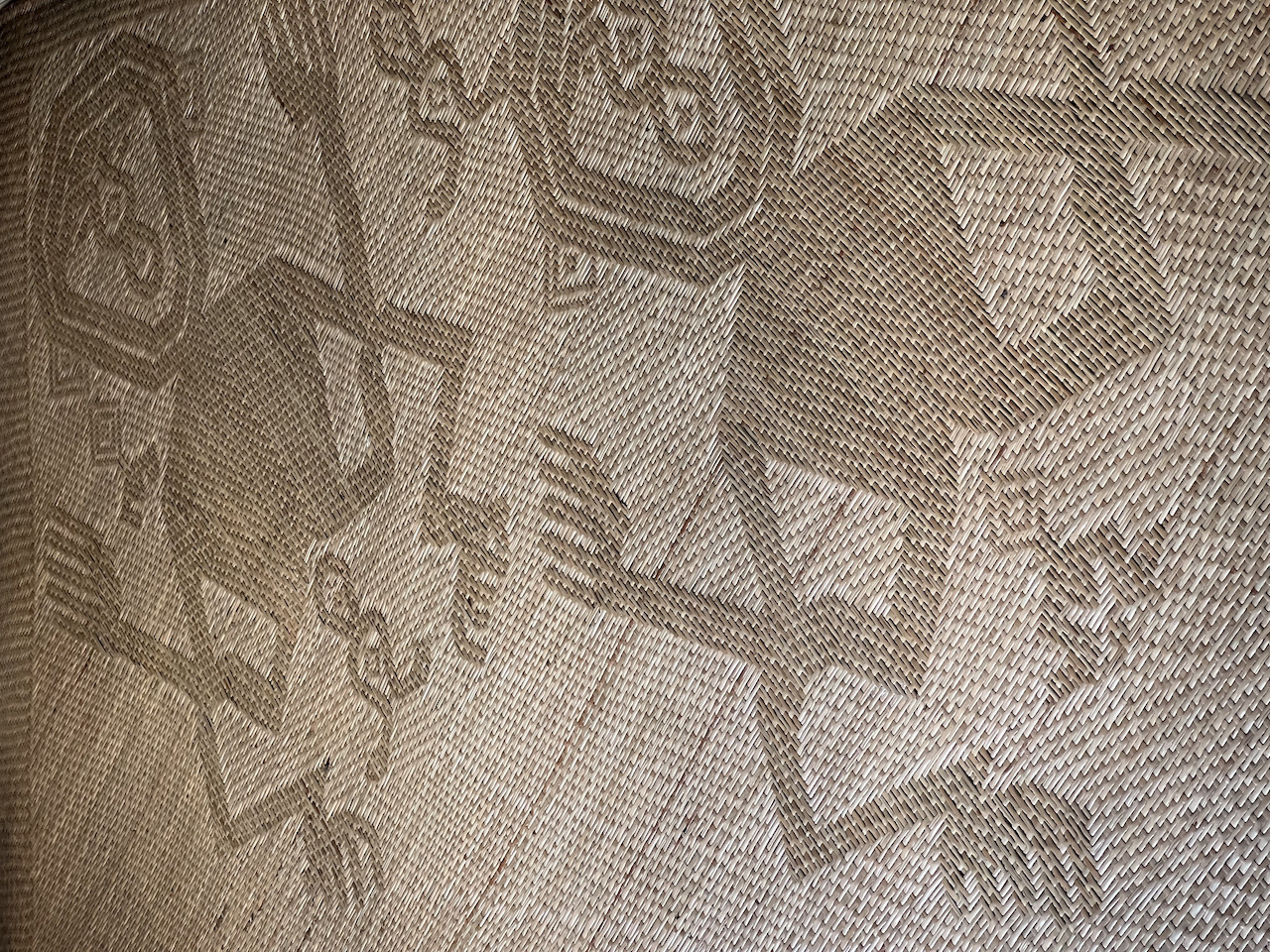 A pattern of Antu Grasi (The hunter ghost) depicted on a bemban (Donax canniformis) mat. According to the artisan, she was obligated to finish the pattern up to the head part by the ghost itself as she was constantly disturbed during her sleep. Antu Grasi is known to resides in large strangler figs, even in one area it is considered their territory.