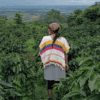 A woman stands among coffee bushes in Colombia. Image courtesy of Juliana Cajiao Raigosa.