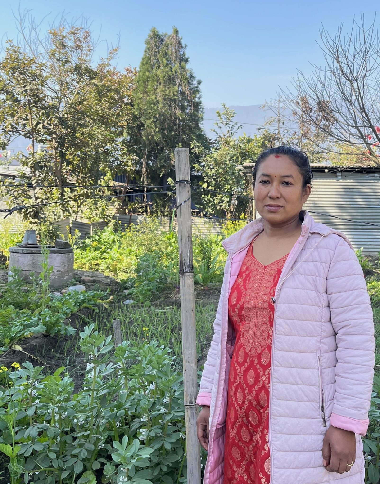 Manhera-Shrestha-poses-for-a-photo-at-her-home-in-Khokana