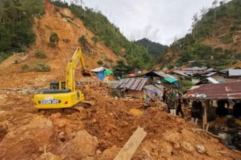 Rescuers search for victims at the site of a landslide in Suwawa on Sulawesi Island in July 2024.
