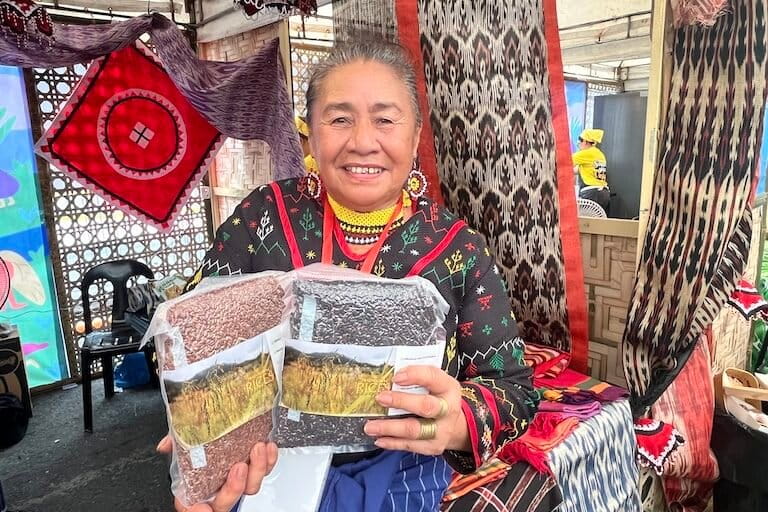 Myrna Pula, a T’boli Indigenous leader from the southern Philippines, showcases heirloom rice varieties that have sustained her community and culture for generations. Image by Keith Anthony Fabro for Mongabay.