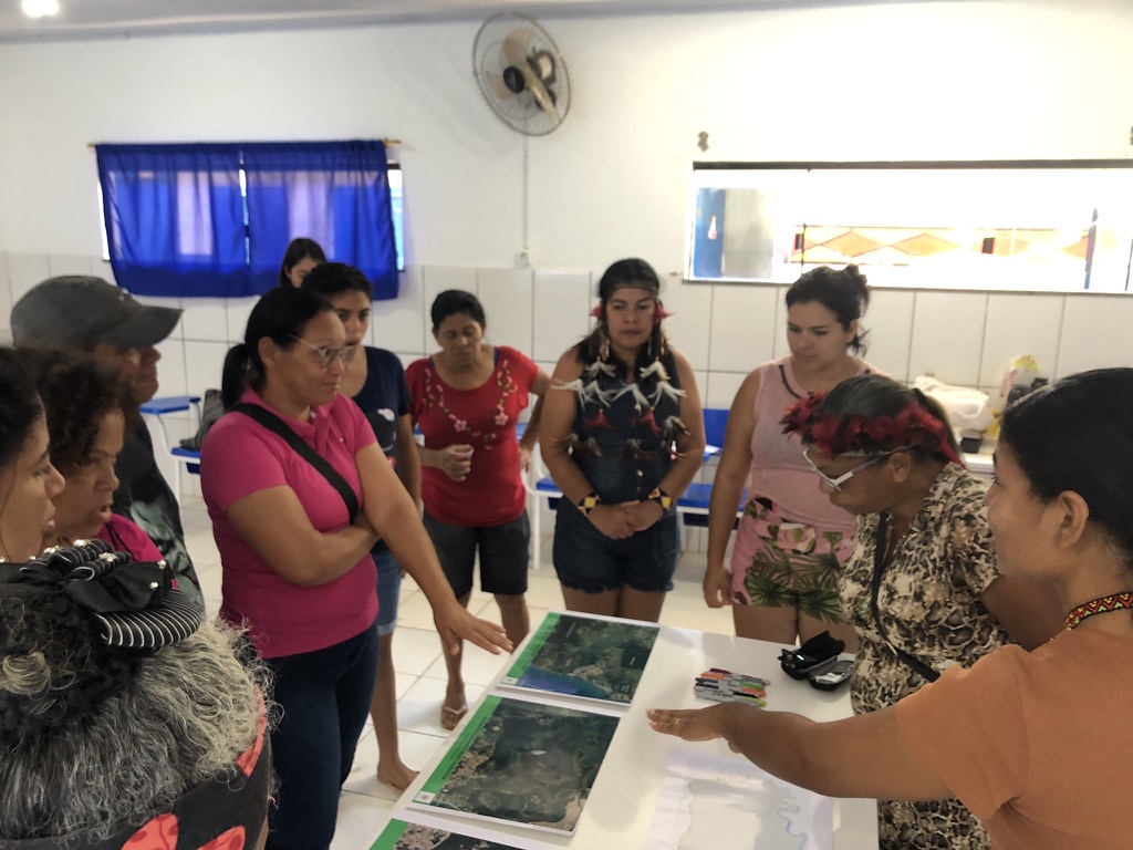 Women from the Indigenous community Aldeia Velha in the south of Bahia, Brazil discuss territorial rights and forest restoration as part of a participatory mapping exercise. Image by Rayna Benzeev.