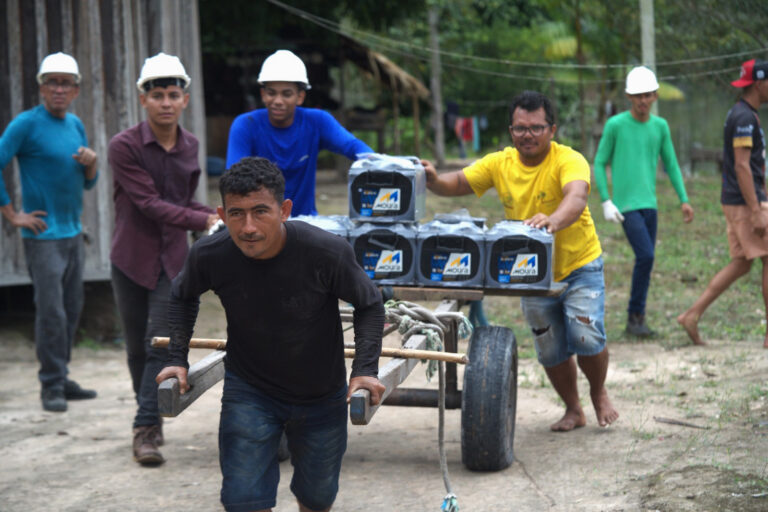 Community members take part in the installation of solar panels in the Porto Rico community, in the Brazilian Amazon.