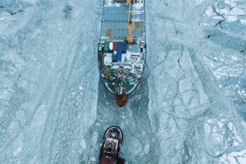 Aerial view as a ship sails through the sea ice in the winter.
