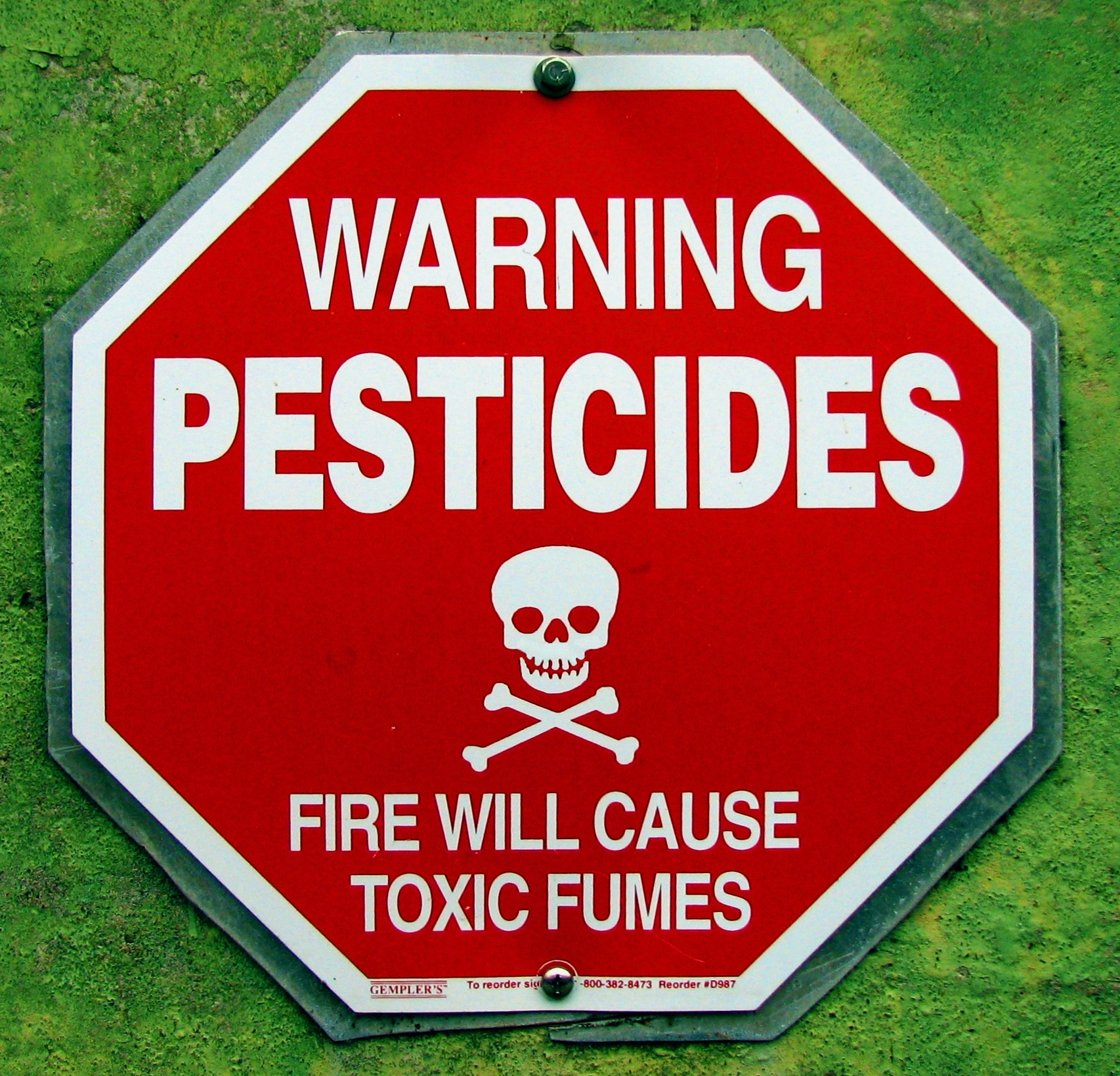 Signs warning of possible exposure to pesticides. 