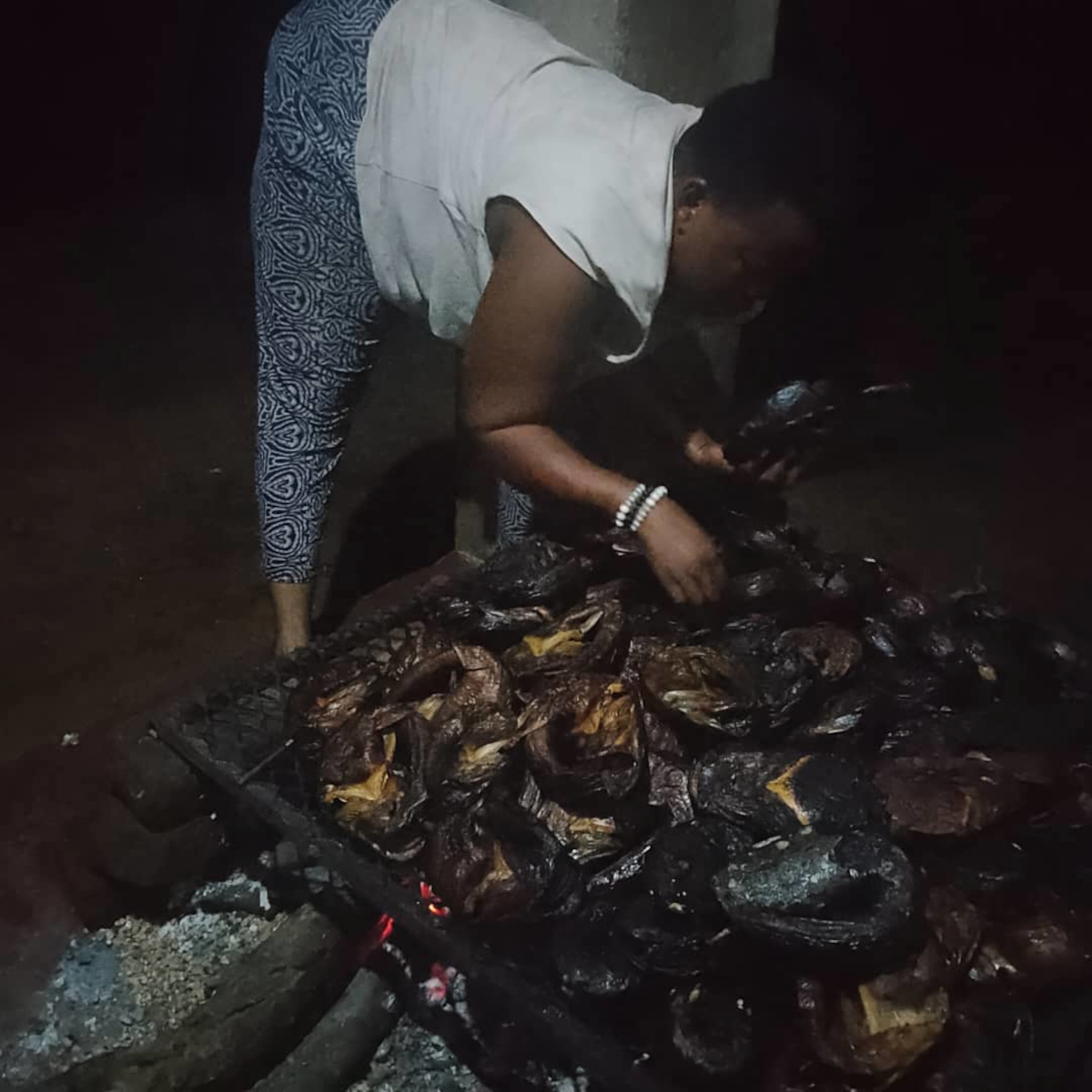 Emma Dzangaya smokes fish for fishers and traders. Image by Charles Mpaka for Mongabay.