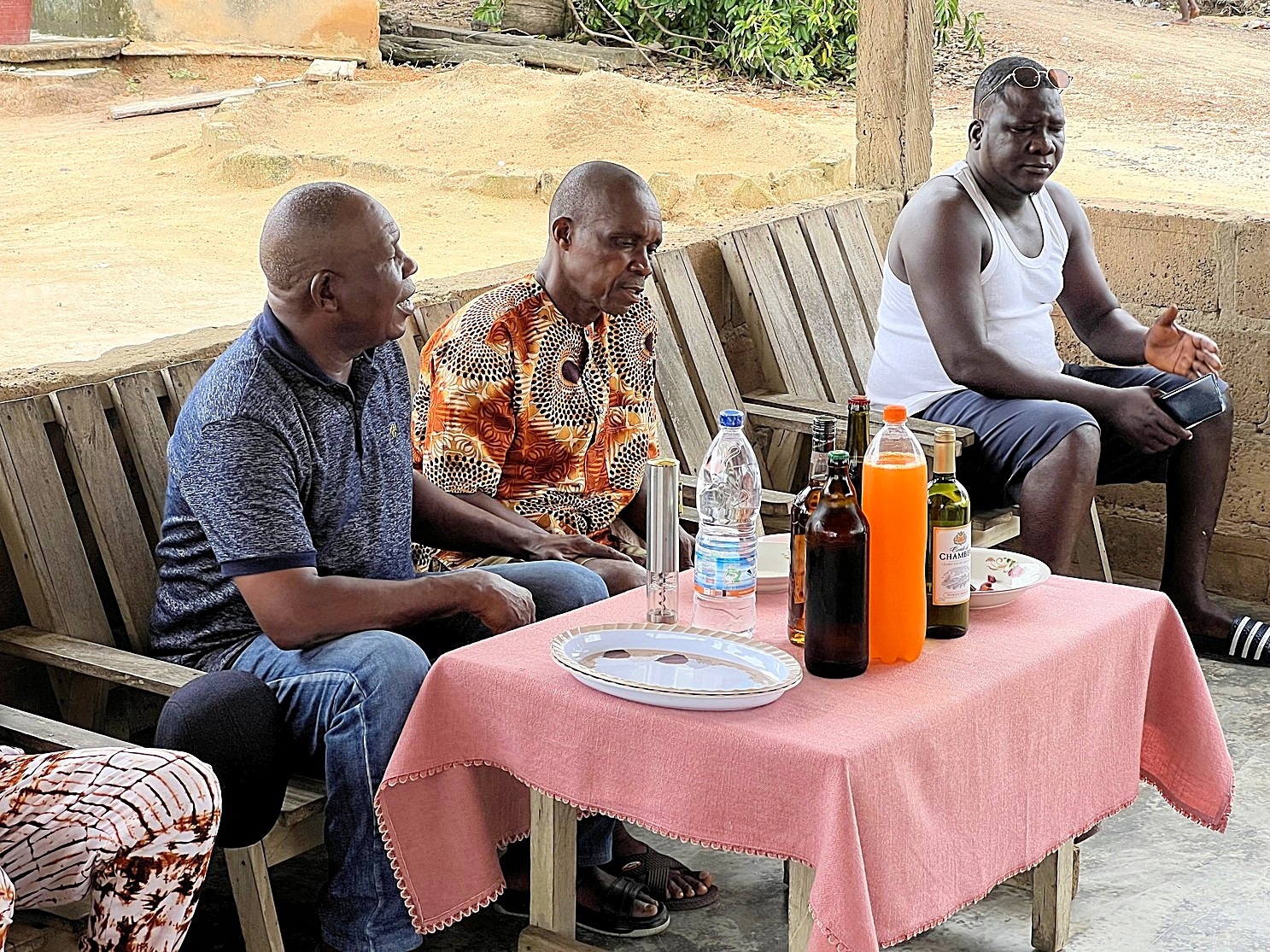 Chief Djahi Bertin, left, and his advisors meet with conservationists and scientists at his residence in the village of Nigré to discuss the creation of an ecological corridor linking the nearby Taï National Park, with Grebo National Park just 4 kilometers away in neighboring Liberia. Image by Ryan Truscott for Mongabay.