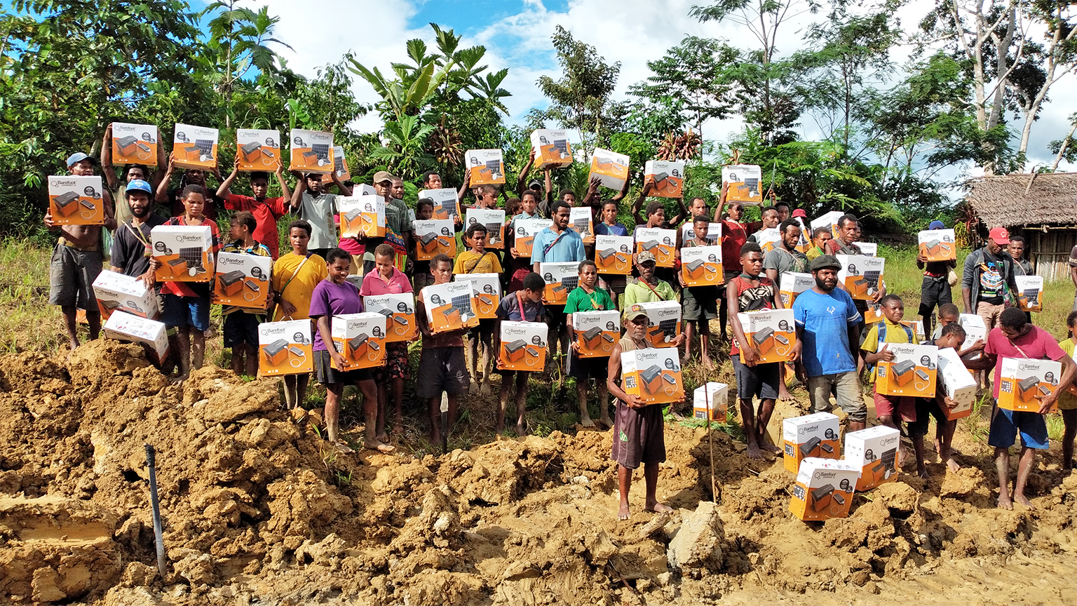Community members display new solar devices as part of TCA programming. Image by James Wareing courtesy of the Tenkile Conservation Alliance.