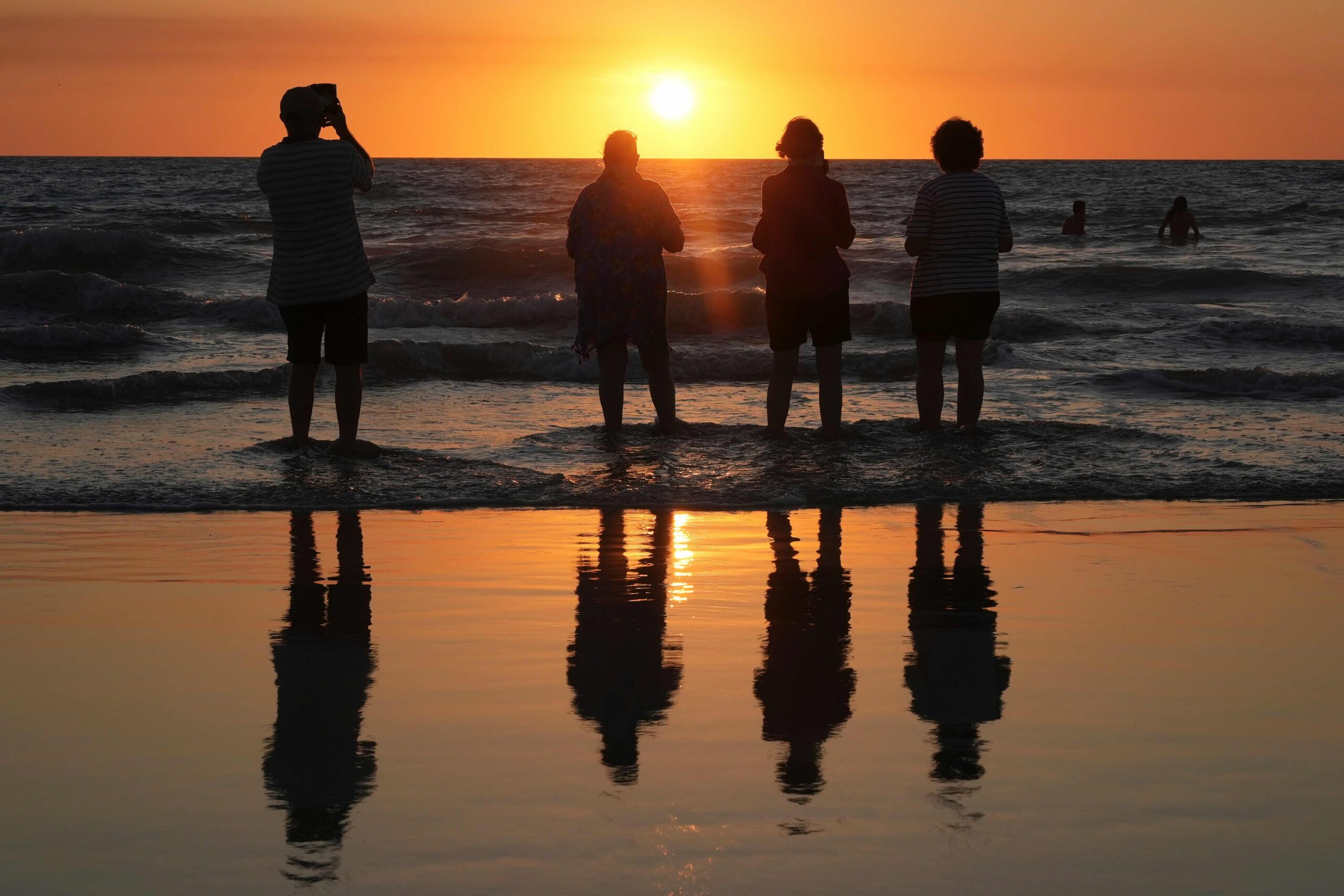 People watch as the sun sets at Cable Beach in Broome, Western Australia, Saturday, Aug. 22, 2026. Image by AP Photo/Mark Baker.