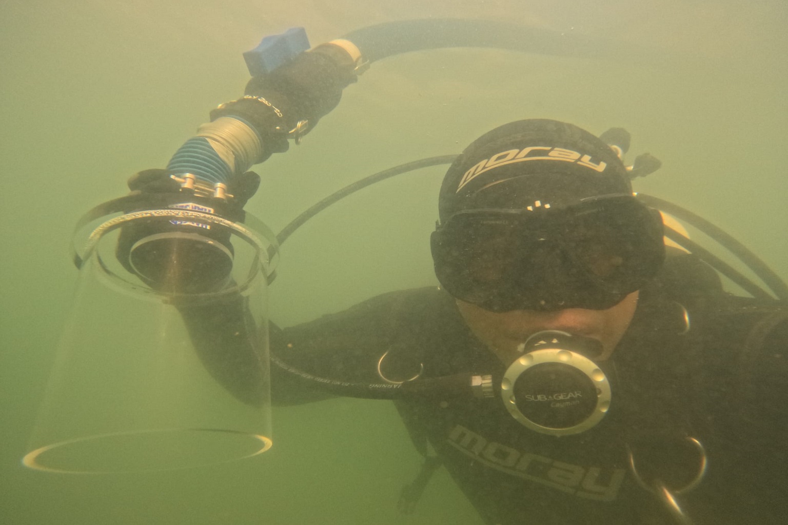 Commercial diver Stephen Te Tai holds one of the suction devices he uses to remove invasive caulerpa from New Zealand's coastal waters.