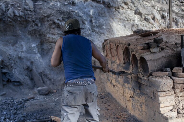 Un trabajadador arroja piedras a un horno para su fundición en la mina de mercurio en Camargo, Peñamiller, Querétaro.