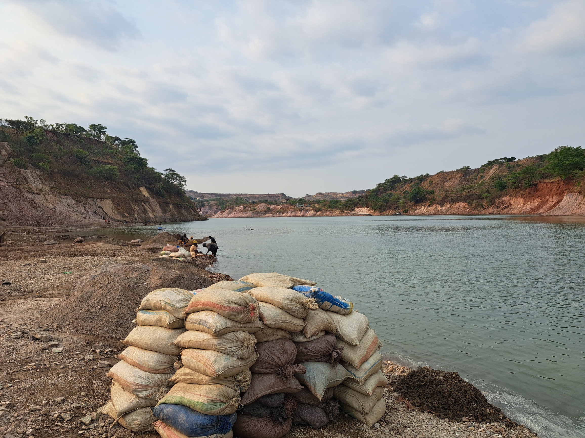 Des sacs de minerais bruts sur le bord du site « Eau bleue » à Kakanda, où opèrent des artisanaux. Image de Didier Makal prise en 2023.