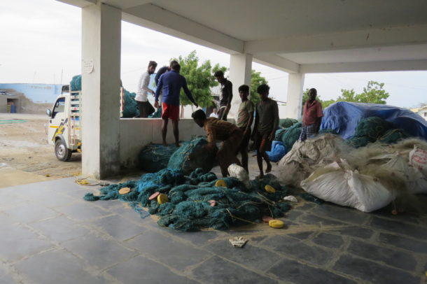 Fishermen bringing back the nets they had repaired at home. Credit: Jency Samuel/Mongabay