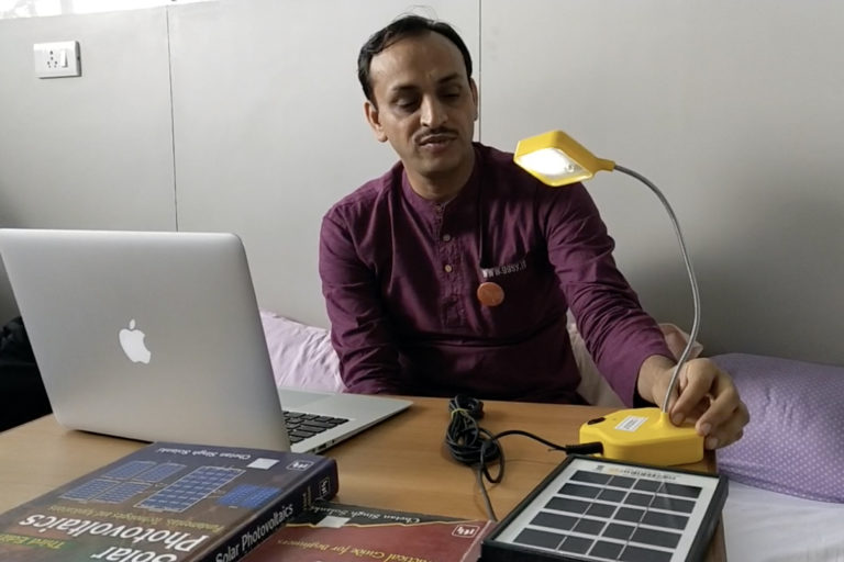 Chetan Singh Solanki, at Indian Institute of Technology, Mumbai, demonstrates the solar lamp made by the SoULS Initiative. Photo by Kanchan Srivastava.