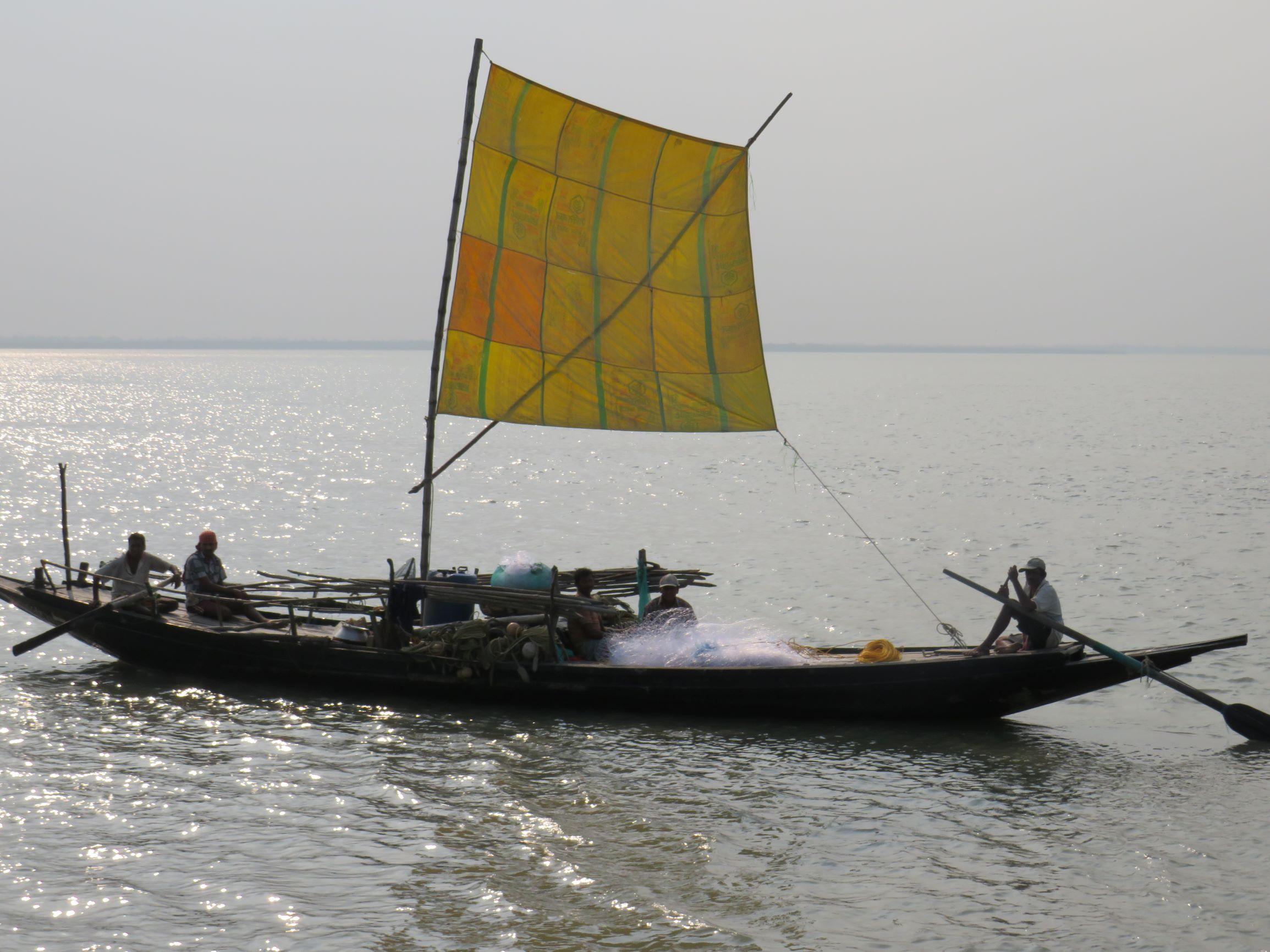 A fisherman on a boat with fishing nets near Diamond Harbor in Sundarbans.Photo by Namrata Acharya.
