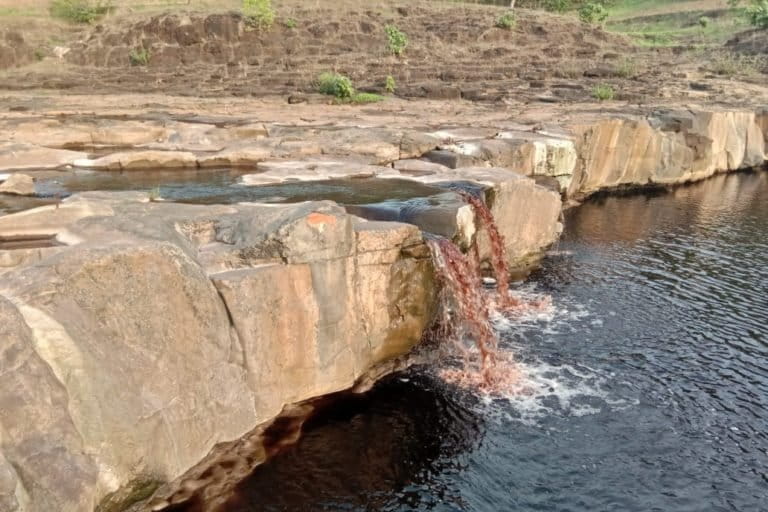 Chemical waste being dumped into Ajnar river is polluting the water and posing risk to the health of local people and animals. Photo by Omkar Singh.