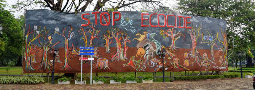 A massive mural saying “Stop Ecocide”