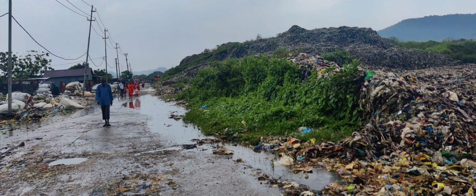 People walking on a road adjacent to the MSW dump