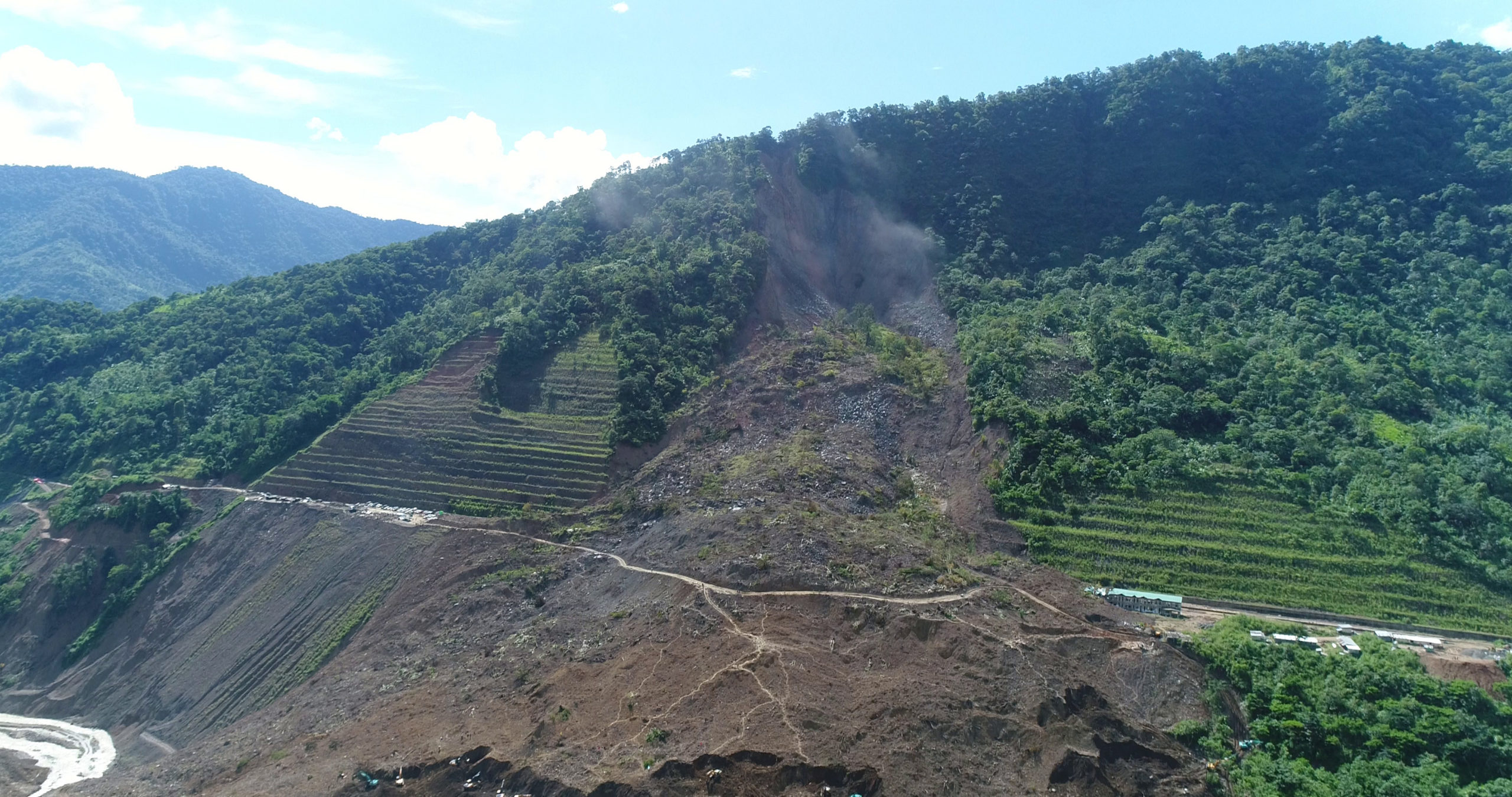 The disaster is being attributed to a combination of factors including excessive rainfall and long-term exposure of cut hill slopes for infrastructure expansion, debris blocking the flow of a river and deforestation. Photo by