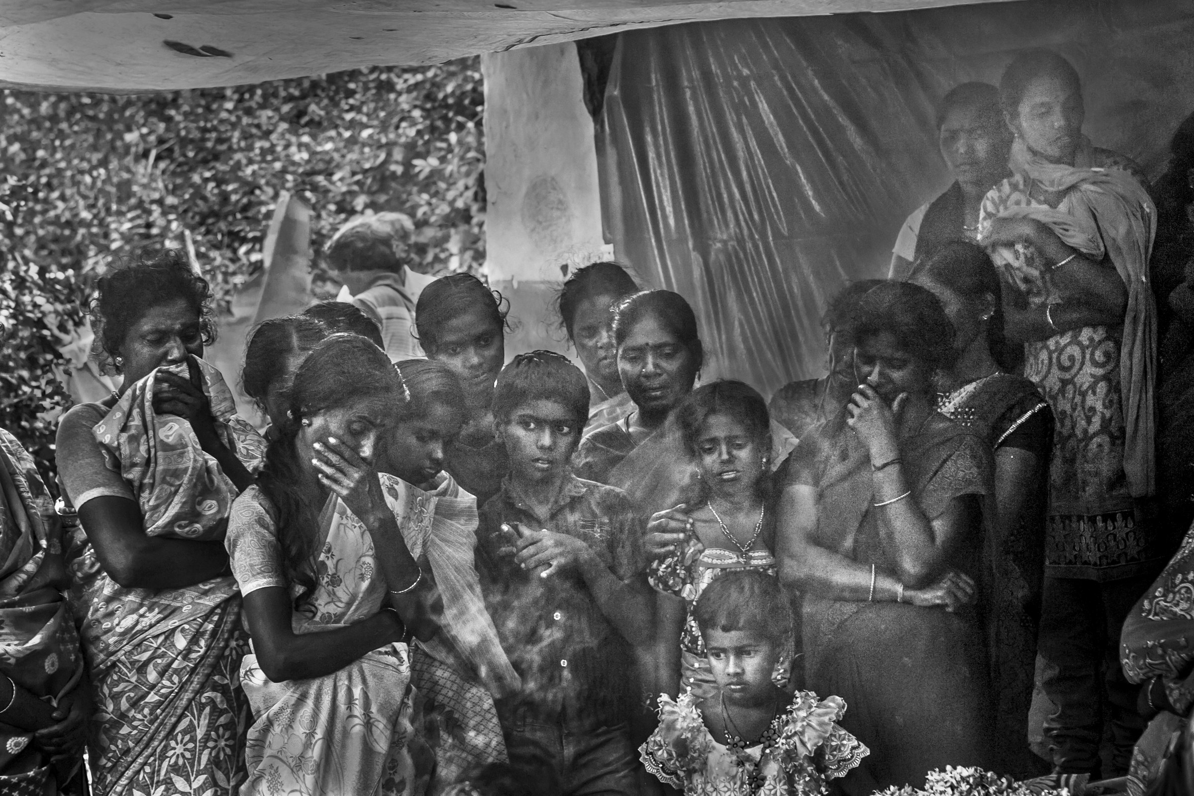 Neighbors mourn the death of a 38-year-old woman who was killed by a tiger while she was working on the tea estate in Pattavayal village in Gudalur, near Mudumalai tiger reserve. Photo by Senthil Kumar.