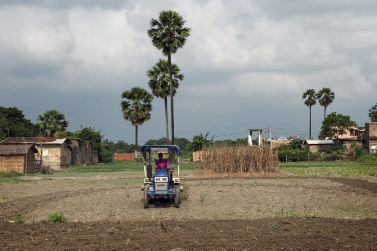 Image shows a tractor on a farm 