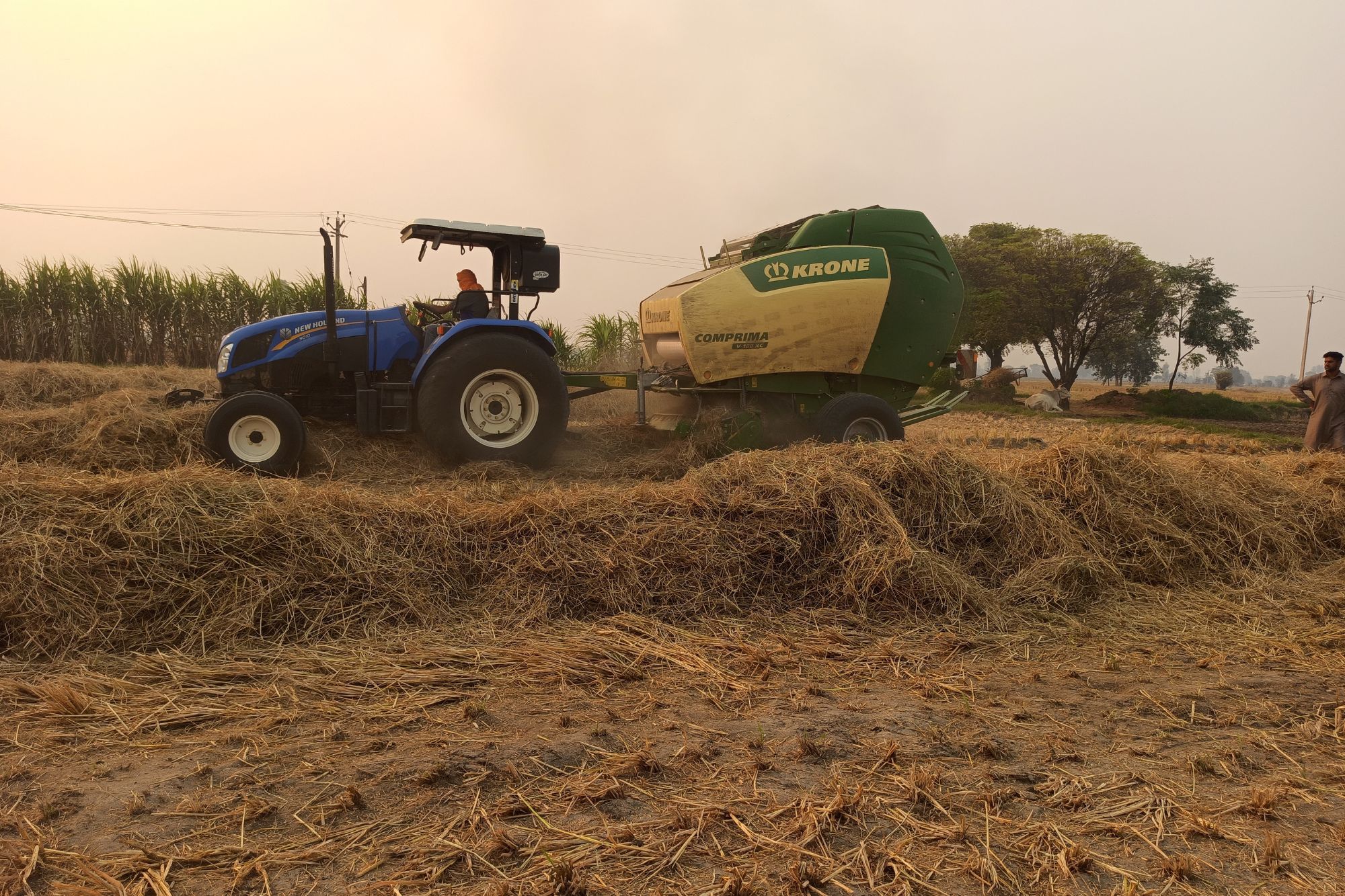 A straw baler at work in Punjab's paddy field. 