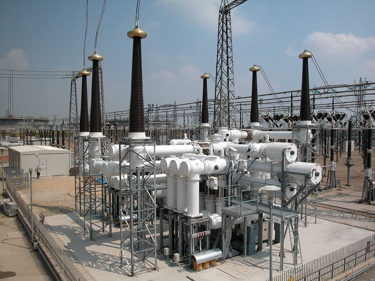 Sulphur hexafluoride gas circuit breakers in a switchyard. Photo by Dingy/Wikimedia Commons.