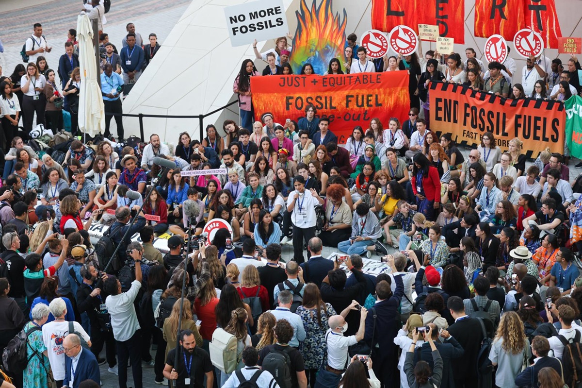 People raising their concerns at COP28 venue. COP28 agreed to transition away from fossil fuels in energy systems. Photo by IISD/ENB/Mike Muzurakis