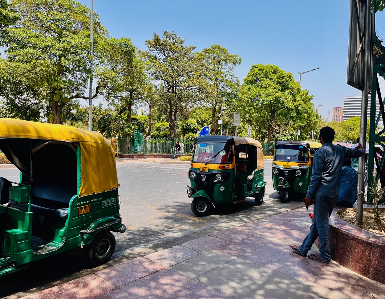 An auto driver seen standing in the shade in Connaught Place while waiting for a cusotmer to arrive. Photo by Pallavi Ghosh