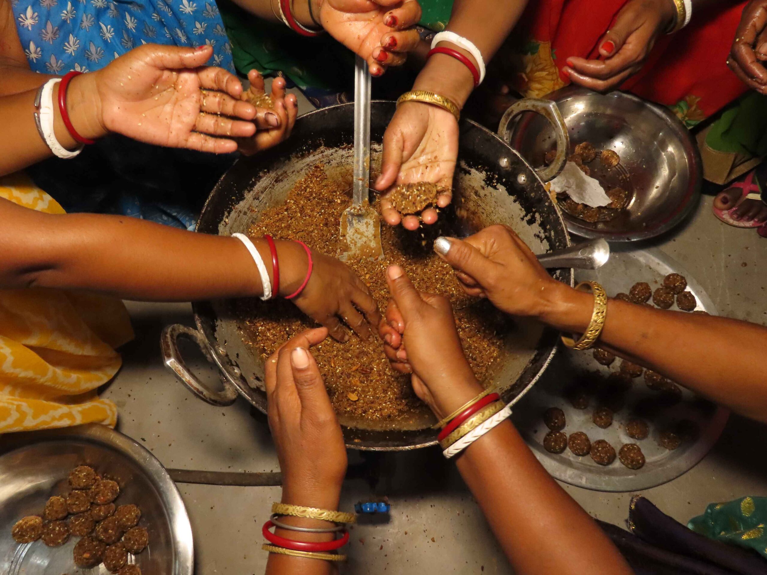 Women preparing mahua laddu. Image by Mukesh Mahato.
