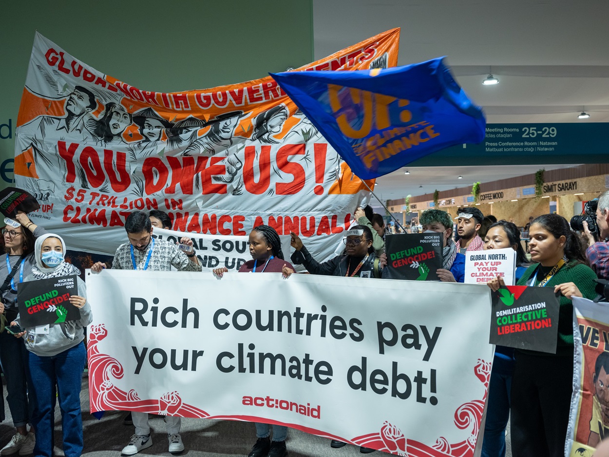 Activists protest at the COP29 venue, urging developed countries to acknowledge their role in the climate crisis. Image courtesy of COP29 Azerbaijan Presidency via flickr.