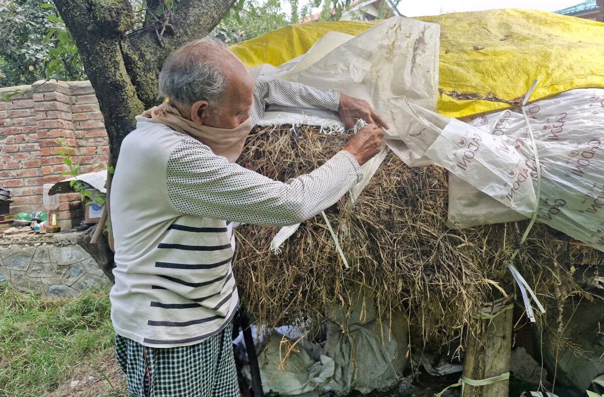 A maize farmer shows how he dries up straw and stores it for his livestock for the winter. Image by Hirra Azmat.