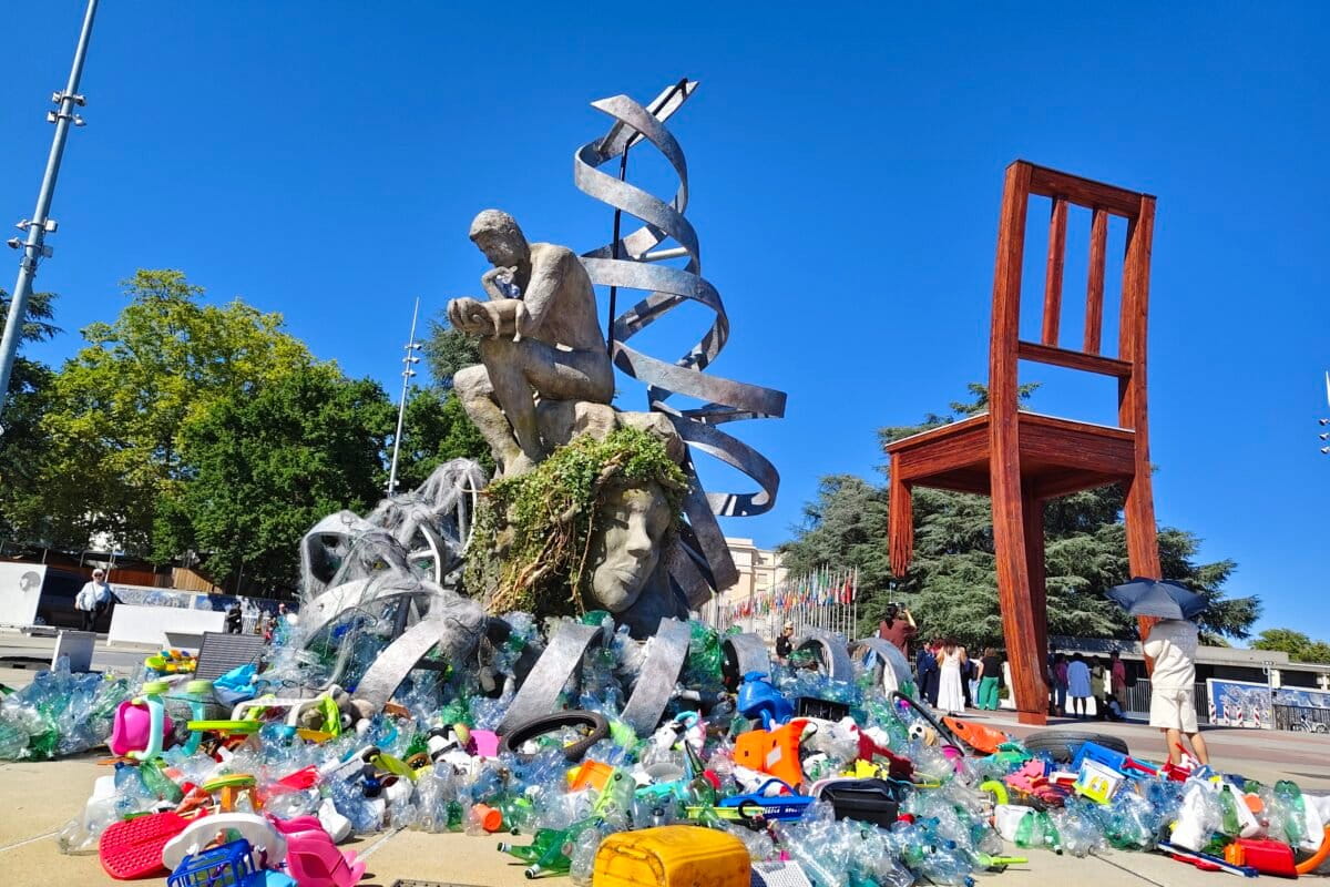 A man with a baby in his arms sat on the sculpture of Mother Earth, surrounded by broken plastic toys, bottles, and chairs scattered around. Every day, some more trash was added. Even as the man is seen thinking, Mother Earth, his own body, and the DNA helix above him, were all covered in plastic. Even as plastic has penetrated the foetus-symbolised by the DNA helix, the sea and the mountains, world leaders procrastinate to agree on a solution.