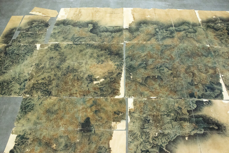 Pieces of a roughly 10x6-foot 1848 map of the Nilgiri hills from the first systematic survey conducted by the British in the region are spread out on a library floor. Image by Vijay Ramesh.