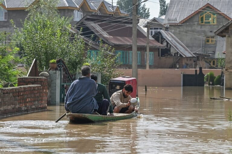 Residents of Shalina, Budgam travel by boat as floodwaters submerge the area. Image by Abid Bhat.
