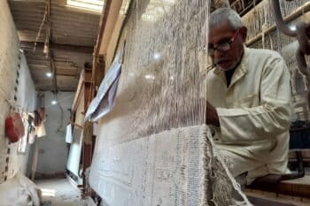 An artisan weaves a hand-tufted carpet in Bhadohi. Image by Aslam Mahboob.