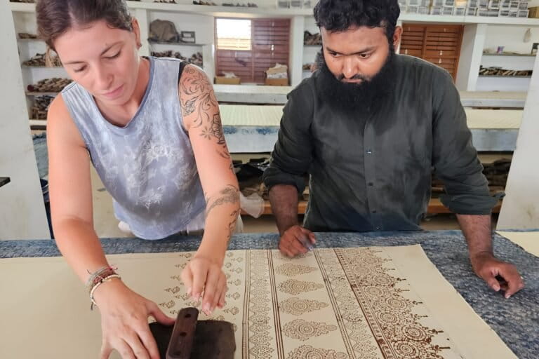 Mohd Soyab Abdul Karim conducts an Ajrakh block printing class for a visitor in Kutch, Gujarat. Image courtesy of Soyab Abdul Karim.