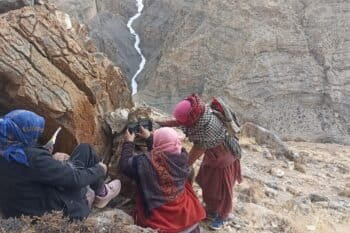 Women from Kibber village set up a camera trap on a steep slope in Spiti Valley during the state-wide snow leopard survey. Image courtesy of the Nature Conservation Foundation and Himachal Pradesh Forest Department.