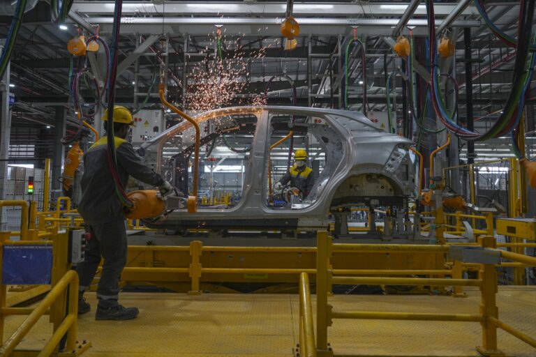 Workers assemble a car at an electric vehicle plant in Thoothukudi, Tamil Nadu. (AP Photo/ Rafiq Maqbool)