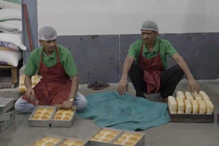 Workers at a bakery get newly baked pav ready for sale. Image by Megha Acharya/Mongabay-India.