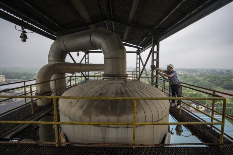 A technician at work at a factory that produces ethanol in Meerut, Uttar Pradesh. (AP Photo/Altaf Qadri)