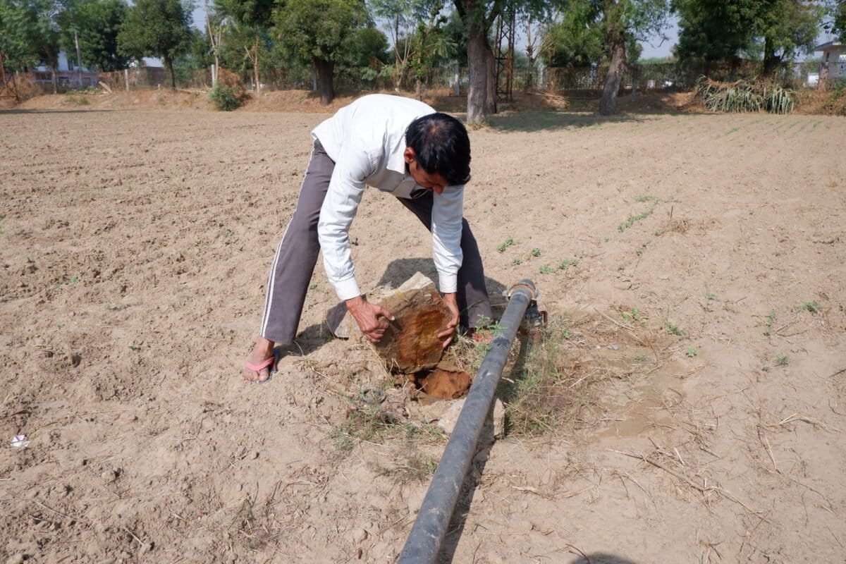 जयपुर जिले के कालाडेरा गांव के किसान लक्ष्मीनारायण यादव अपने सूखे ट्यूबवेल को दिखाते हुए। यादव का परिवार एक अति-दोहन वाले ब्लॉक में संघर्ष कर रहा है और पिछले पांच सालों में छः ट्यूबवेल के लिए लिए गए कर्ज में डूबा हुआ है। तस्वीर -अश्विनी कुमार शुक्ला।
